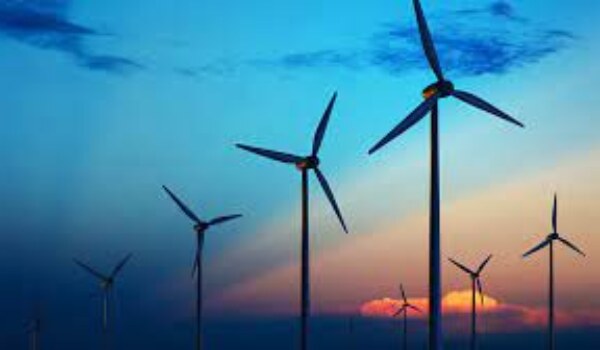 How do wind turbines convert kinetic energy into electricity?